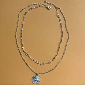 Gold tone layered necklace with Lion amulet.